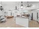 Bright open concept area with tile floors, ceiling fans, and kitchen island with seating at 9911 Mendel Dr, New Port Richey, FL 34654