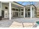 Covered patio with columns, ceiling fans, and an easy flow into the screened pool area at 9911 Mendel Dr, New Port Richey, FL 34654