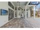 Expansive patio featuring an outdoor refrigerator, recessed lighting, and ceiling fans at 9911 Mendel Dr, New Port Richey, FL 34654