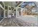 The covered patio offers ample space and overlooks a screened pool with a water feature at 9911 Mendel Dr, New Port Richey, FL 34654