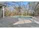 The screened pool area boasts ample deck space and an elegant statue at 9911 Mendel Dr, New Port Richey, FL 34654