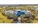 View of community center surrounded by lush landscaping, palm trees, and green lawns at 12015 Lansing Gln, Parrish, FL 34219