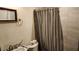 Small bathroom with tiled shower, toilet, sink, and mirror at 1207 Pine Nw Ave, Largo, FL 33770