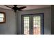 A bright room featuring a ceiling fan and french doors that lead to an outdoor patio at 1207 Pine Nw Ave, Largo, FL 33770