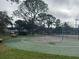 Outdoor basketball court with green and red surface and nearby park benches at 121 Loblolly Ct # H, Oldsmar, FL 34677
