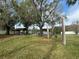 Community park area with covered picnic tables, swings, and large shade trees at 121 Loblolly Ct # H, Oldsmar, FL 34677
