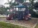 Community playground with multiple slides and climbing structures in a wooded setting at 121 Loblolly Ct # H, Oldsmar, FL 34677