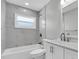 Clean bathroom with a bathtub and shower combination, window and modern vanity at 1230 75Th N Ave, St Petersburg, FL 33702