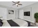 Comfortable bedroom with a ceiling fan, closet, and a wall-mounted TV for relaxation and convenience at 1230 75Th N Ave, St Petersburg, FL 33702