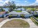Charming single-story home with a circular driveway and lake view at 1230 75Th N Ave, St Petersburg, FL 33702