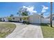 Charming single-story home with a circular driveway and well-manicured landscaping at 1230 75Th N Ave, St Petersburg, FL 33702