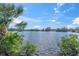 Scenic lake view with lush greenery along the shoreline, offering a tranquil natural setting at 1230 75Th N Ave, St Petersburg, FL 33702