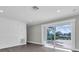 Bright living room with large sliding glass doors and luxury vinyl plank flooring at 1230 75Th N Ave, St Petersburg, FL 33702