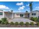 A spacious patio area, featuring a decorative paver design surrounded by well-manicured landscaping at 1230 75Th N Ave, St Petersburg, FL 33702