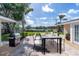 Outdoor dining area with grill, table, and lakeside view for relaxing and entertaining at 1230 75Th N Ave, St Petersburg, FL 33702