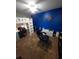 Bedroom with a loft bed, blue accent wall, chair, desk and a white toy chest at 12413 Oak Cedar Pl # 201, Tampa, FL 33612