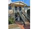 Exterior front view of a two-story building with black stairs, doors, and window trim at 12413 Oak Cedar Pl # 201, Tampa, FL 33612