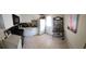 Functional kitchen featuring white cabinets, appliances, tile floor, and a shelved cart at 12413 Oak Cedar Pl # 201, Tampa, FL 33612