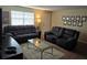 Cozy living room with modern furniture, neutral walls and carpet, and bright window light at 12413 Oak Cedar Pl # 201, Tampa, FL 33612