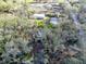 An aerial view of the property showing the house and detached garage, and the surrounding neighborhood at 12950 Lincoln Rd, Riverview, FL 33578