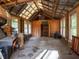 Barn interior featuring wood construction, high ceilings, natural light, and a ladder to access a small loft area at 12950 Lincoln Rd, Riverview, FL 33578