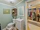 A vintage bathroom with a white vanity and a walk-in closet at 12950 Lincoln Rd, Riverview, FL 33578