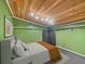 Bedroom with a ceiling made of planked wood and bright green walls at 12950 Lincoln Rd, Riverview, FL 33578