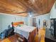 Bedroom featuring wood floors and ceiling, with ensuite bathroom at 12950 Lincoln Rd, Riverview, FL 33578