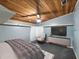 Comfortable bedroom with a wood plank ceiling and an accent wall at 12950 Lincoln Rd, Riverview, FL 33578