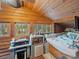 Bedroom featuring natural wood walls and ceiling, with a daybed and exterior views at 12950 Lincoln Rd, Riverview, FL 33578