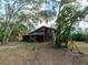 Exterior view of the house surrounded by lush trees, front yard and natural landscaping at 12950 Lincoln Rd, Riverview, FL 33578