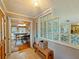 Inviting hallway featuring unique glass block wall detail and a glimpse into the dining and kitchen area at 12950 Lincoln Rd, Riverview, FL 33578