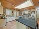 Bright kitchen features black tiled countertops, a skylight, and updated appliances and fixtures at 12950 Lincoln Rd, Riverview, FL 33578