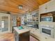 Bright kitchen features black tiled countertops, a skylight, and updated appliances and fixtures at 12950 Lincoln Rd, Riverview, FL 33578