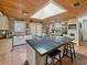 Bright kitchen features black tiled countertops, a skylight, and updated appliances and fixtures at 12950 Lincoln Rd, Riverview, FL 33578