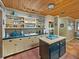 Bright kitchen features black tiled countertops, a skylight, and updated appliances and fixtures at 12950 Lincoln Rd, Riverview, FL 33578