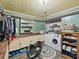 Laundry room with shelving, cabinets, closet, washing machine, and dryer at 12950 Lincoln Rd, Riverview, FL 33578