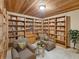 Charming library with floor-to-ceiling bookshelves and cozy armchairs at 12950 Lincoln Rd, Riverview, FL 33578