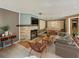 Spacious living room with stone fireplace, a pool table, and plenty of seating at 12950 Lincoln Rd, Riverview, FL 33578