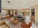 Inviting living room with a pool table, comfortable seating, and unique rustic stairs at 12950 Lincoln Rd, Riverview, FL 33578