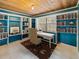 Bright home office featuring built-in bookshelves and a comfortable workspace at 12950 Lincoln Rd, Riverview, FL 33578