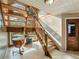 Bright staircase featuring wood stairs and large windows overlooking the yard at 12950 Lincoln Rd, Riverview, FL 33578