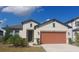 Charming single-story home features a well-manicured lawn, neutral paint, and a two-car garage at 13515 Palmera Vista Dr, Riverview, FL 33579