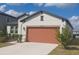 Well-maintained home with manicured lawn, neutral paint, and an attached two-car garage at 13515 Palmera Vista Dr, Riverview, FL 33579