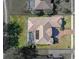 Aerial view of the property with a screened pool, tiled roof, and landscaped yard at 13854 Thoroughbred Dr, Dade City, FL 33525