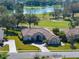 Stunning aerial of home showing the lush golf course and lake behind the property at 13854 Thoroughbred Dr, Dade City, FL 33525