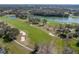 Aerial view of the golf course and lake, showcasing the community's serene environment at 13854 Thoroughbred Dr, Dade City, FL 33525