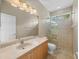 Bright bathroom featuring a single vanity and walk-in shower at 13854 Thoroughbred Dr, Dade City, FL 33525