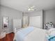 Spacious bedroom featuring hardwood floors, a ceiling fan, and double closet doors with a book case at 13854 Thoroughbred Dr, Dade City, FL 33525