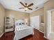 Bedroom with ceiling fan, hardwood floors, and a double door closet at 13854 Thoroughbred Dr, Dade City, FL 33525